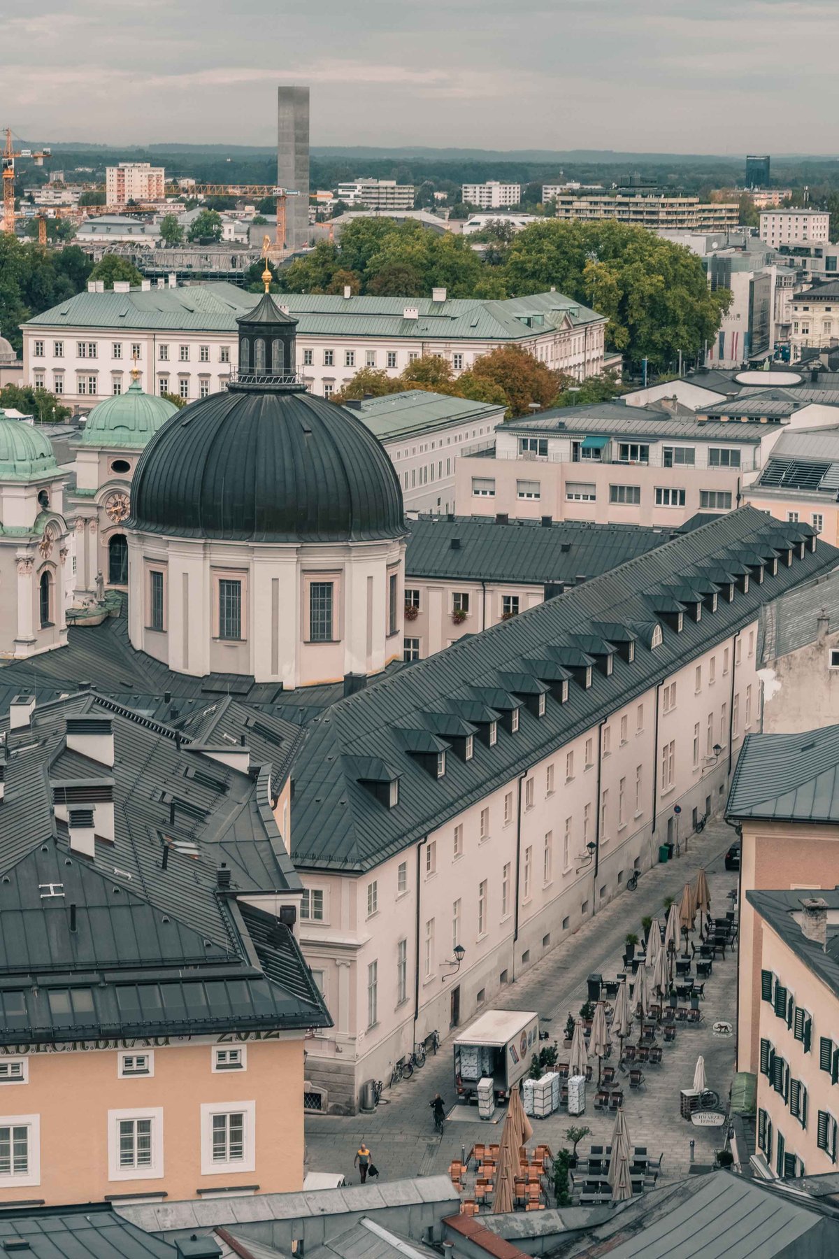 Dreifaltigkeitskirche green dome and long monastery roof in Salzburg Neustadt seen from above