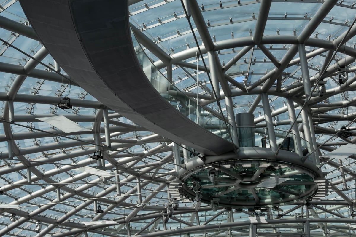 The steel and glass ceiling lattice of the Hangar-7 dome seen from inside in Salzburg.