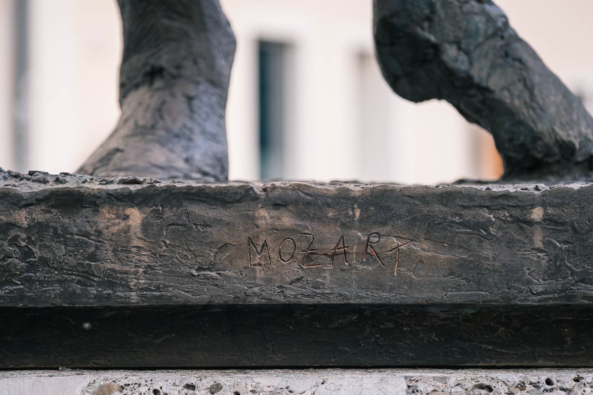 Close-up of the MOZART inscription carved into the base of the Homage to Mozart sculpture in Salzburg.