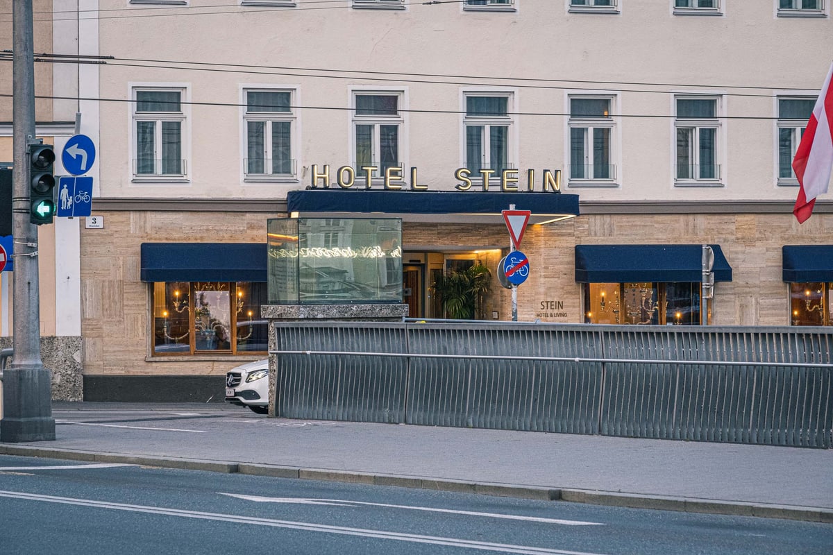 Hotel Stein entrance with golden signage on the Salzach riverfront in Salzburg