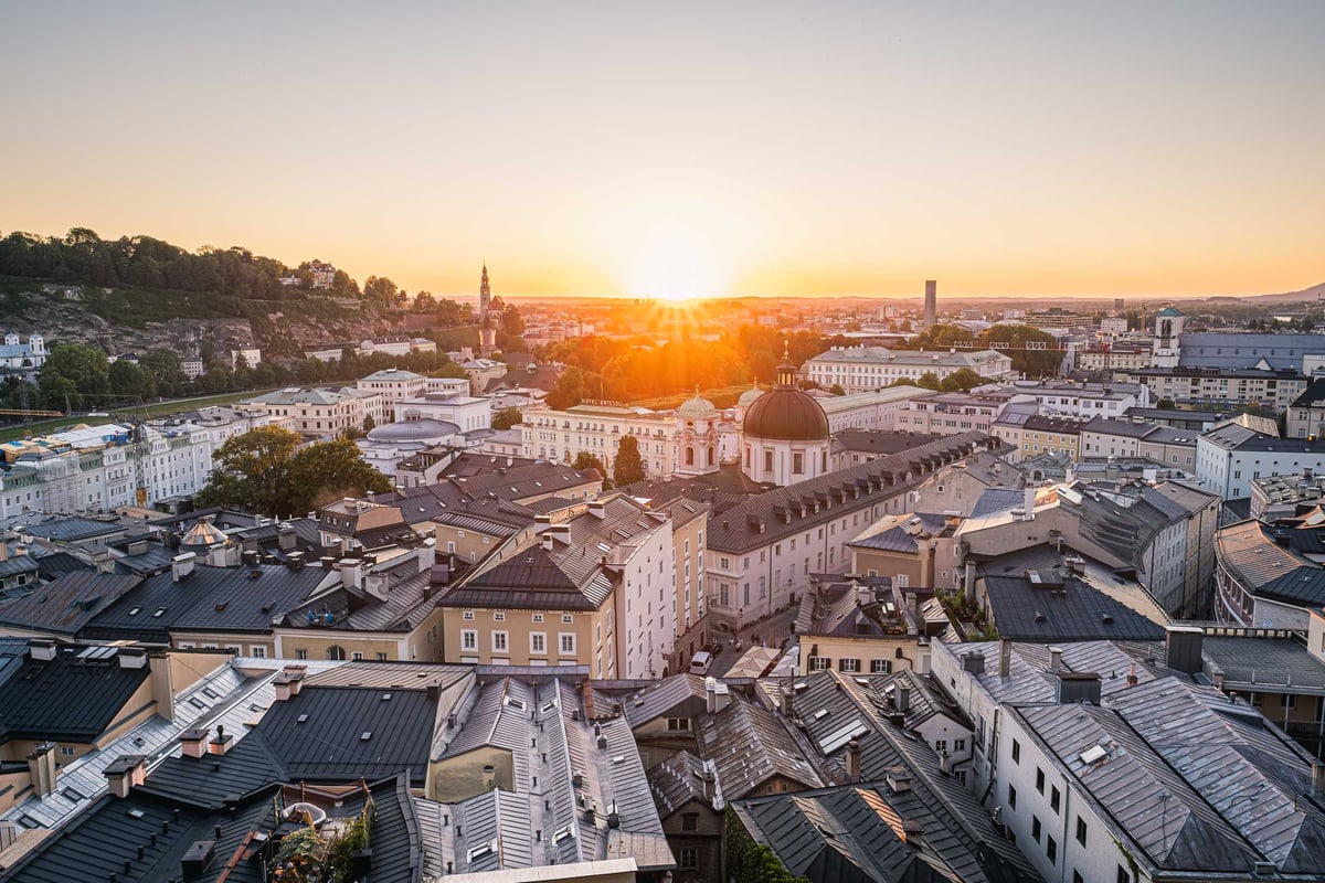 Salzburg old town panorama at sunset with Dreifaltigkeitskirche dome from Kapuzinerberg viewpoint.