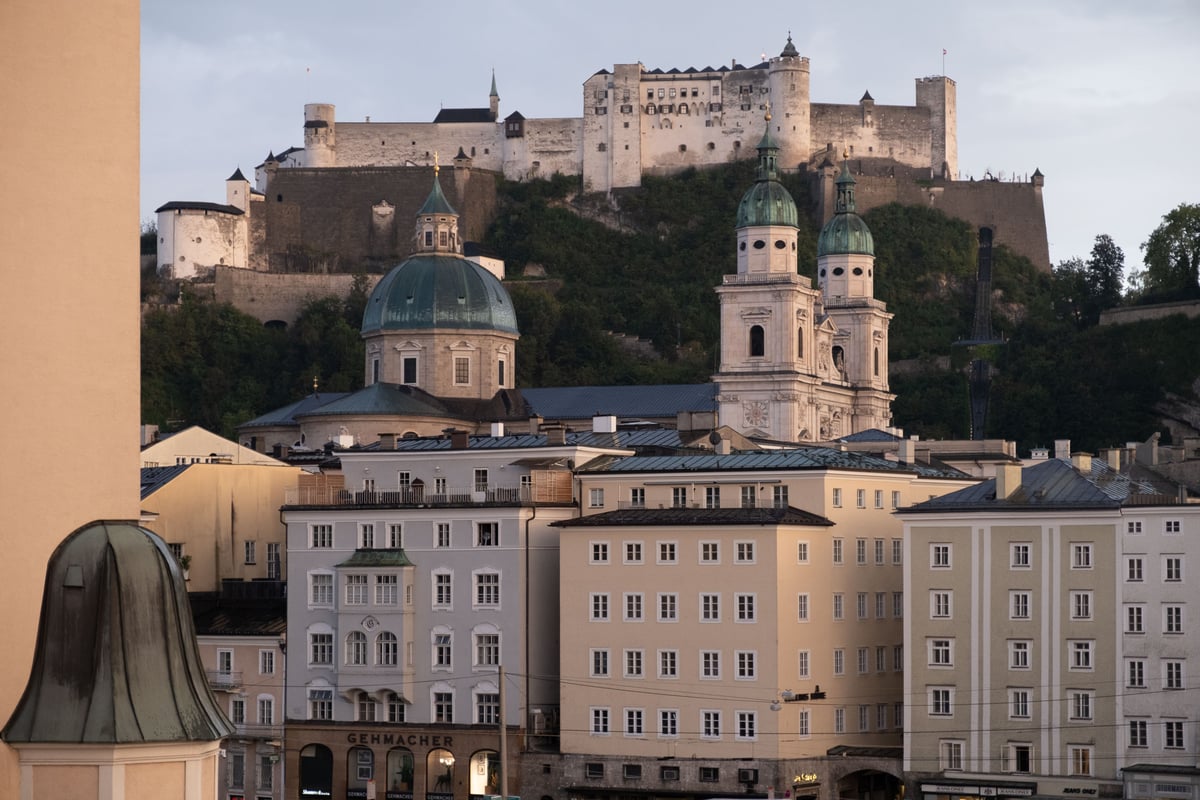 Aerial view of Michaelskirche on Residenzplatz surrounded by old town rooftops in Salzburg