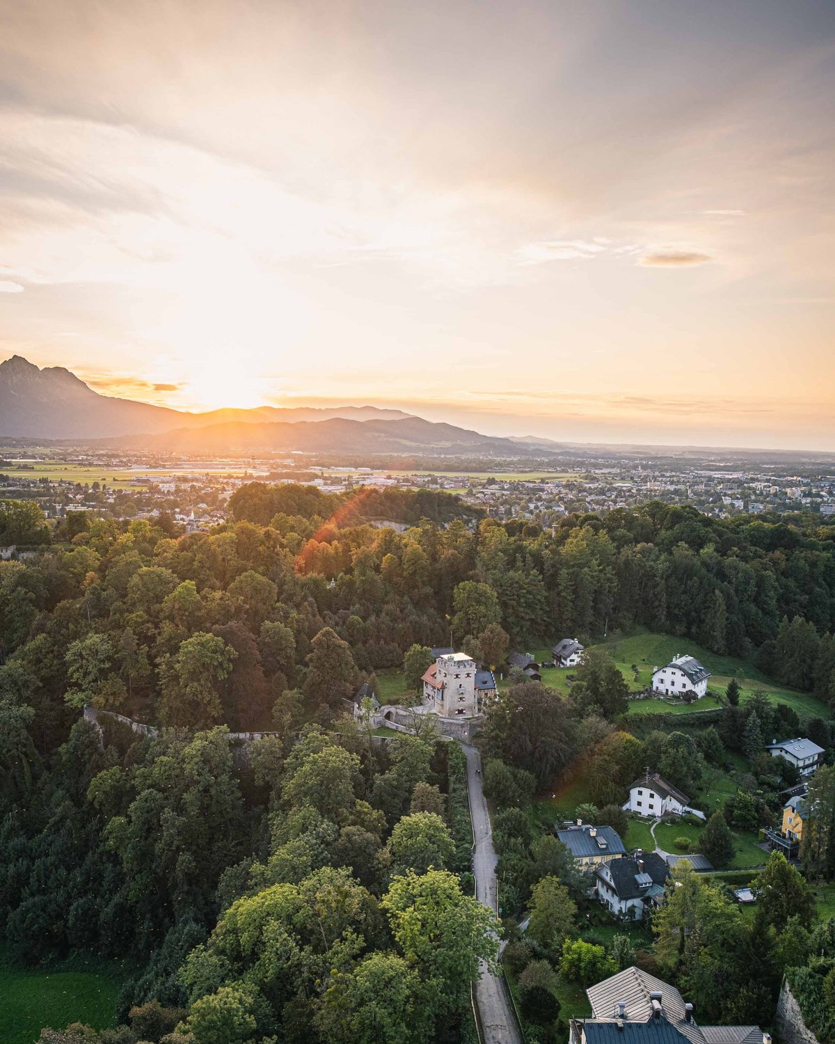 Aerial sunset view of a forested area on the Moenchsberg in Salzburg