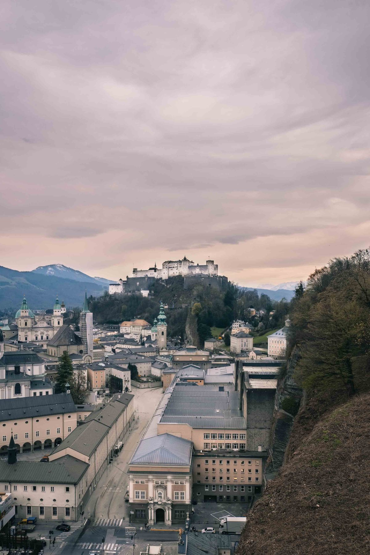 Elevated view of Salzburg Altstadt rooftops with Hohensalzburg Fortress and Salzburger Dom from Moenchsberg.