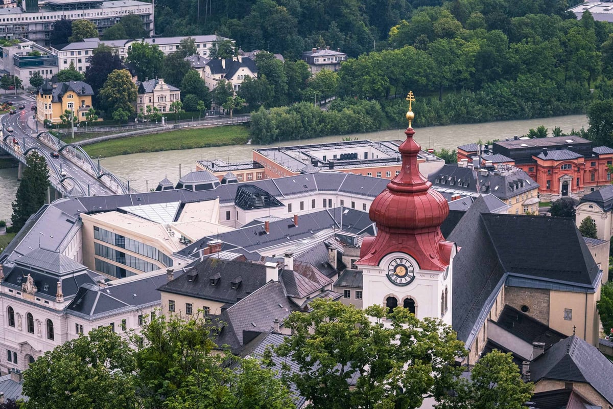 Aerial view of Nonnberg Abbey with its tall onion-domed bell tower above the Salzburg old town