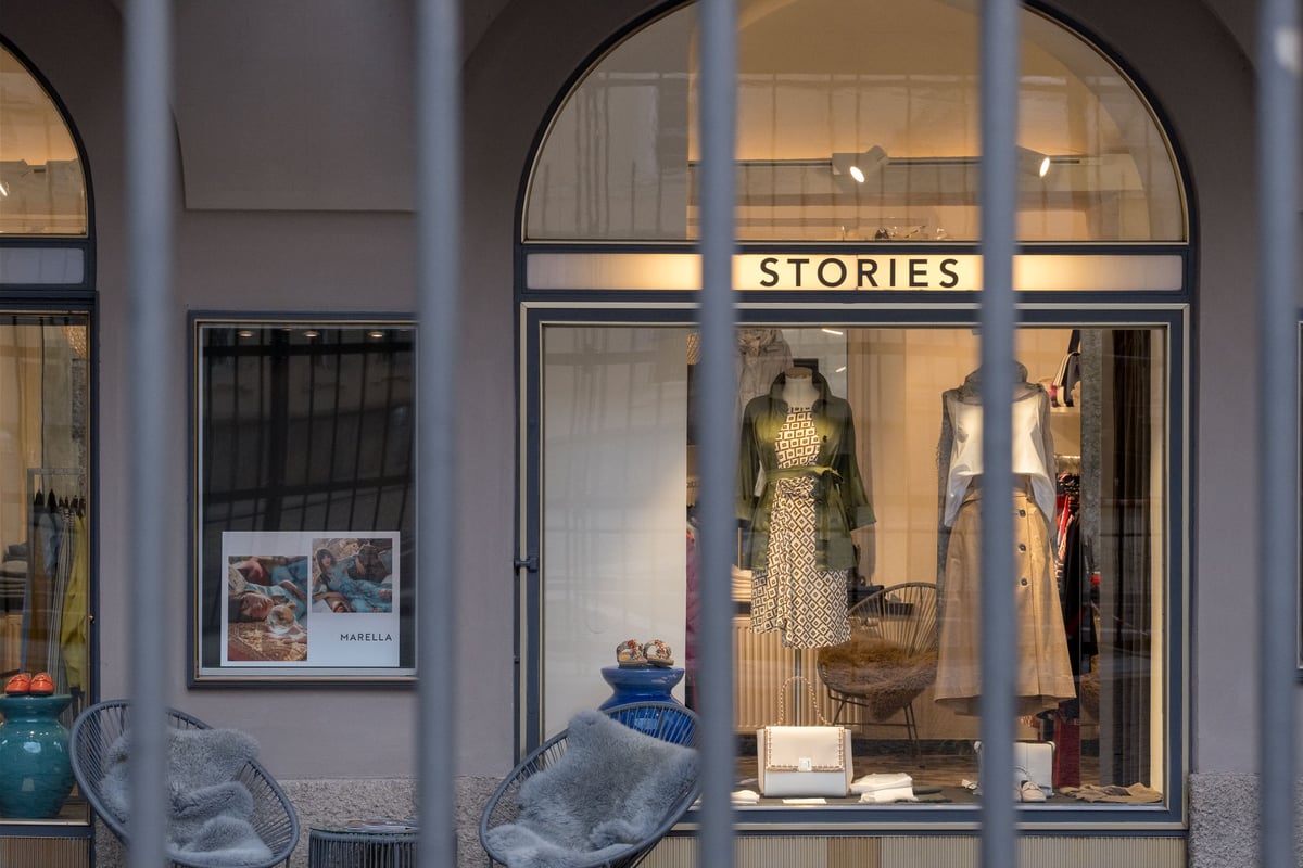 STORIES boutique storefront with a Marella display behind a metal arcade gate on Sigmund-Haffner-Gasse in the Salzburg Altstadt
