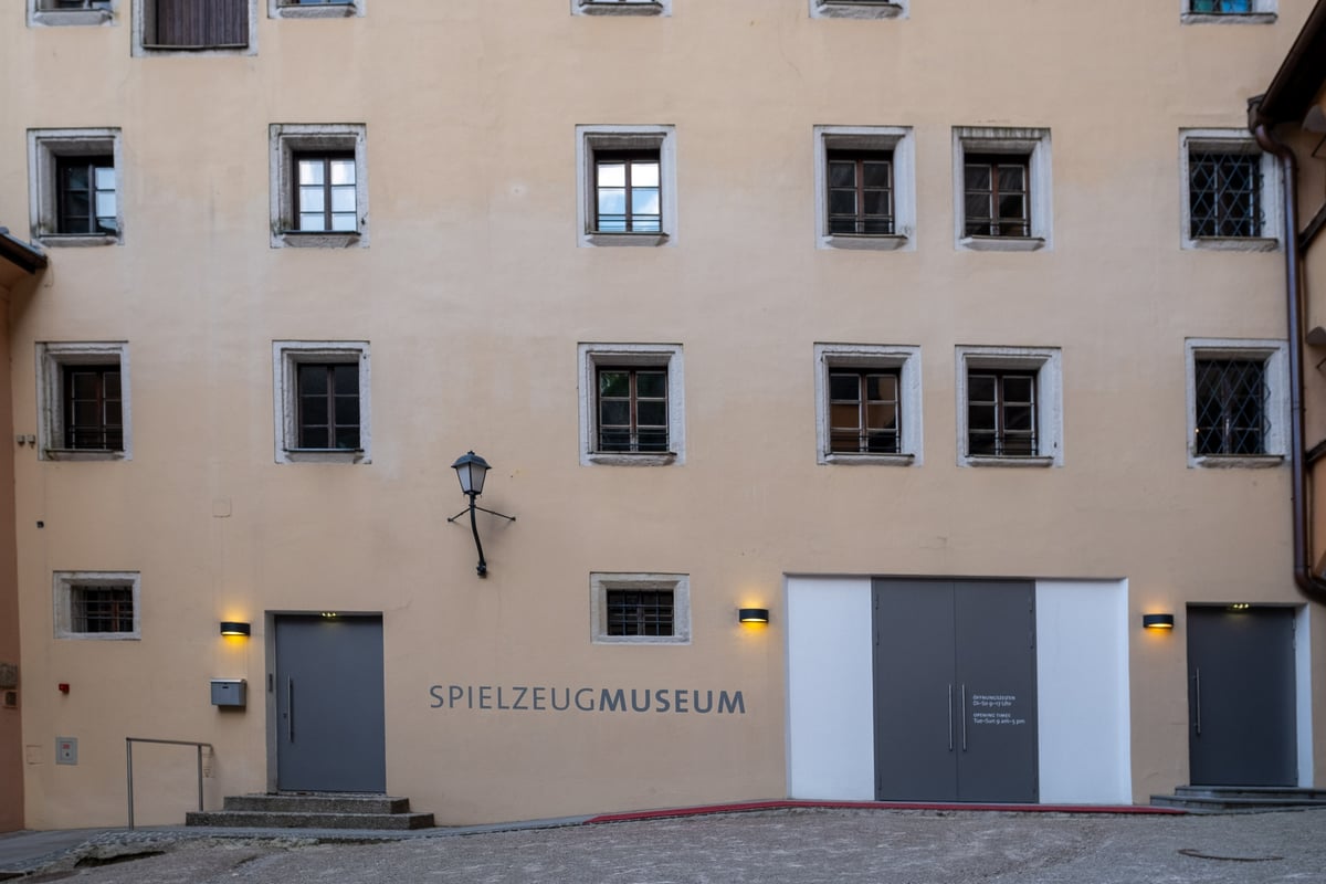 Spielzeugmuseum courtyard facade with signage and historic windows in Salzburg old town
