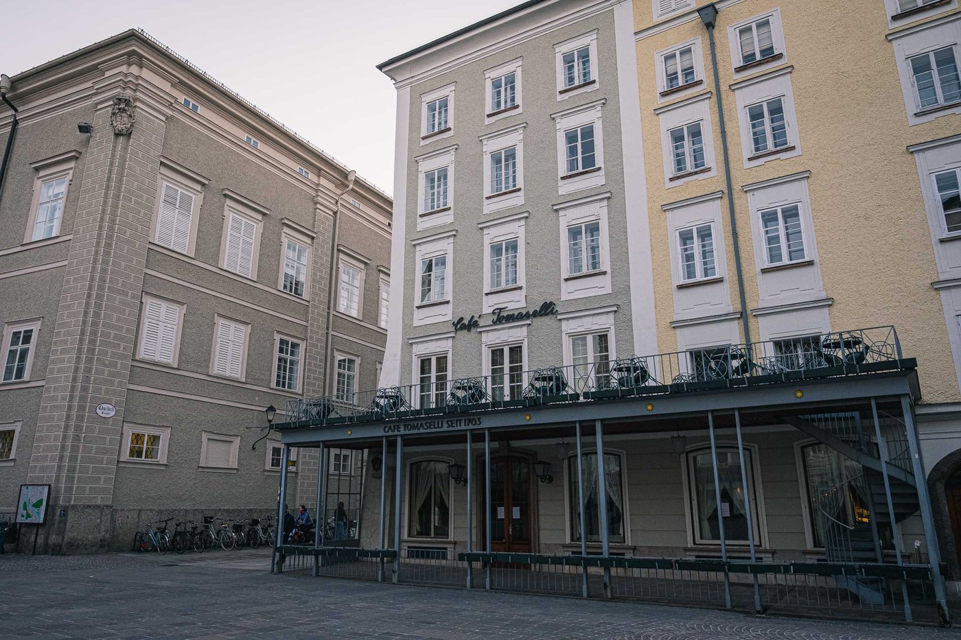 Cafe Tomaselli covered terrace on Alter Markt square in Salzburg old town.