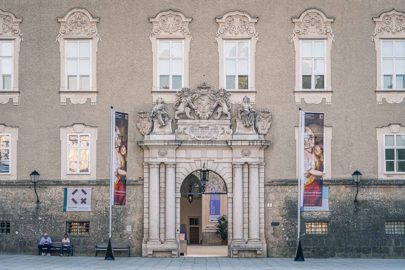 Baroque portal entrance of DomQuartier museum with heraldic coat of arms above the door in Salzburg