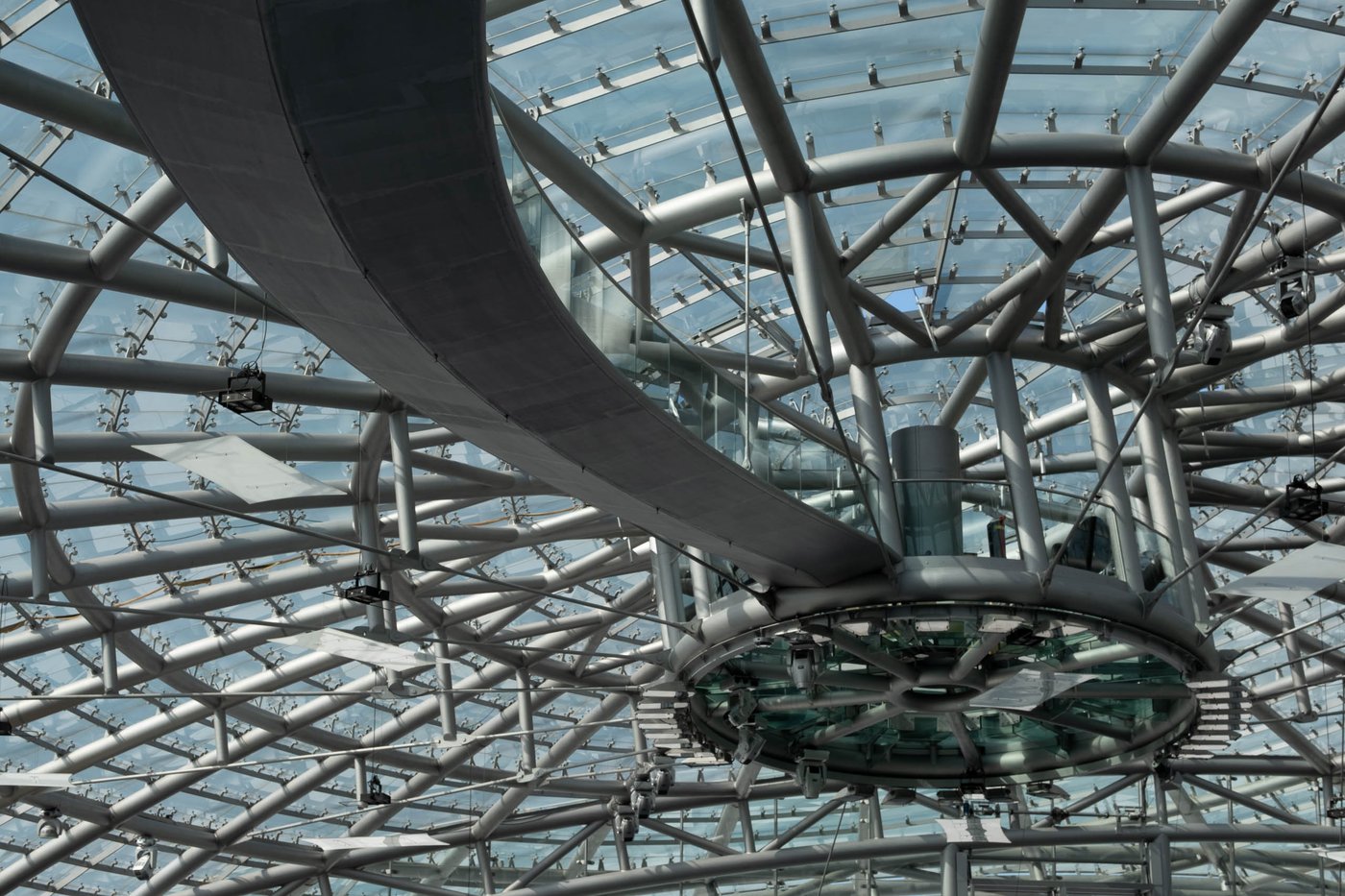 The steel and glass ceiling lattice of the Hangar-7 dome seen from inside in Salzburg.