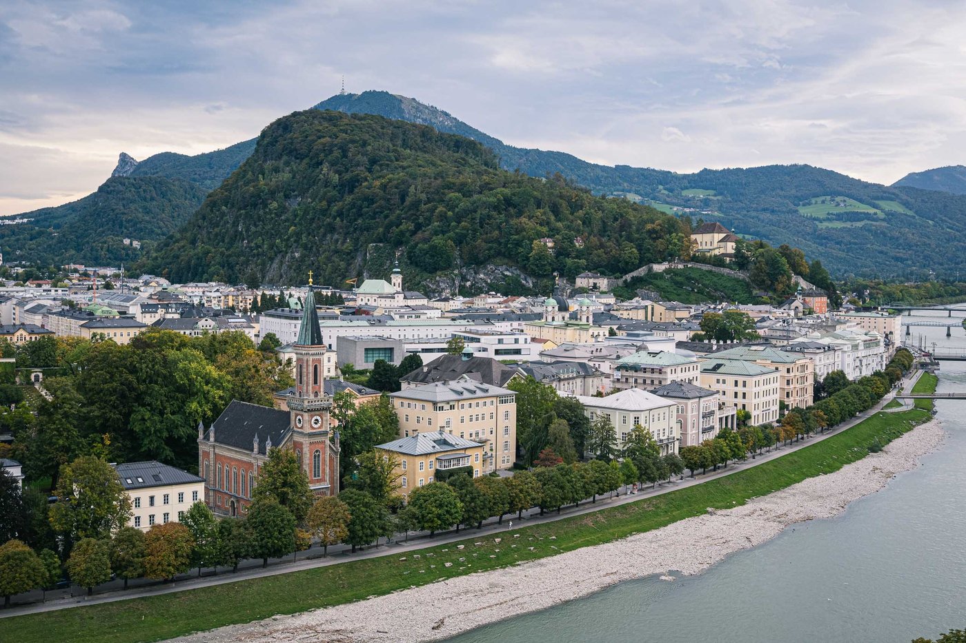 View over Salzburg Neustadt along the Salzach with Gaisberg and Nockstein peaks behind the city.