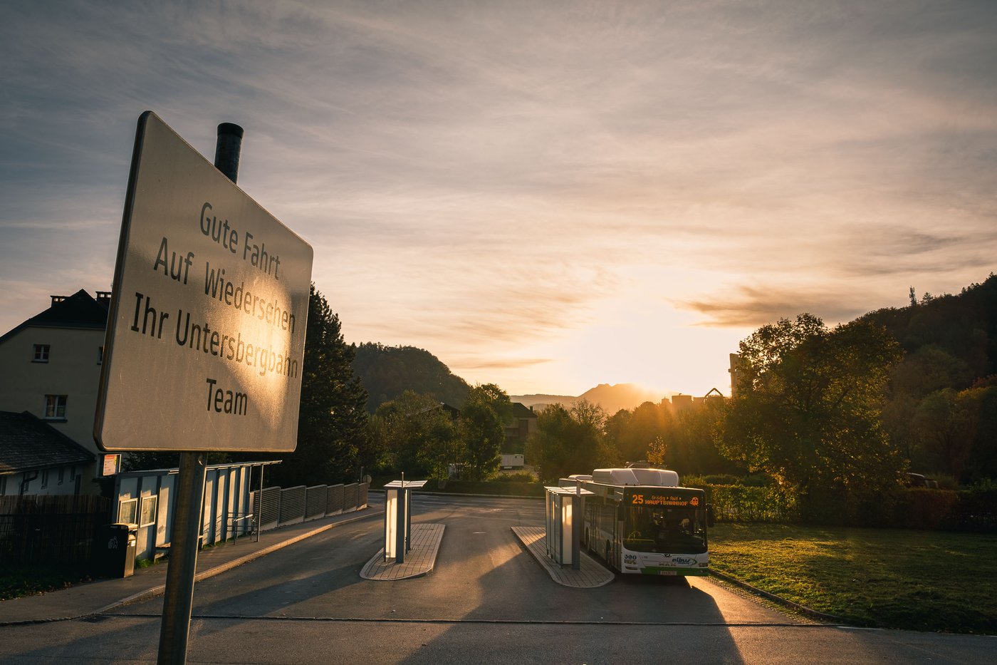 Bus 25 at the Untersbergbahn terminus with goodbye sign at sunrise in Groedig
