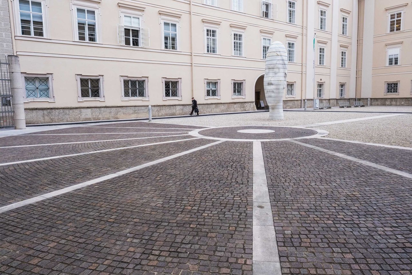 Awilda sculpture stands in the cobbled Residenz inner courtyard in Salzburg old town.