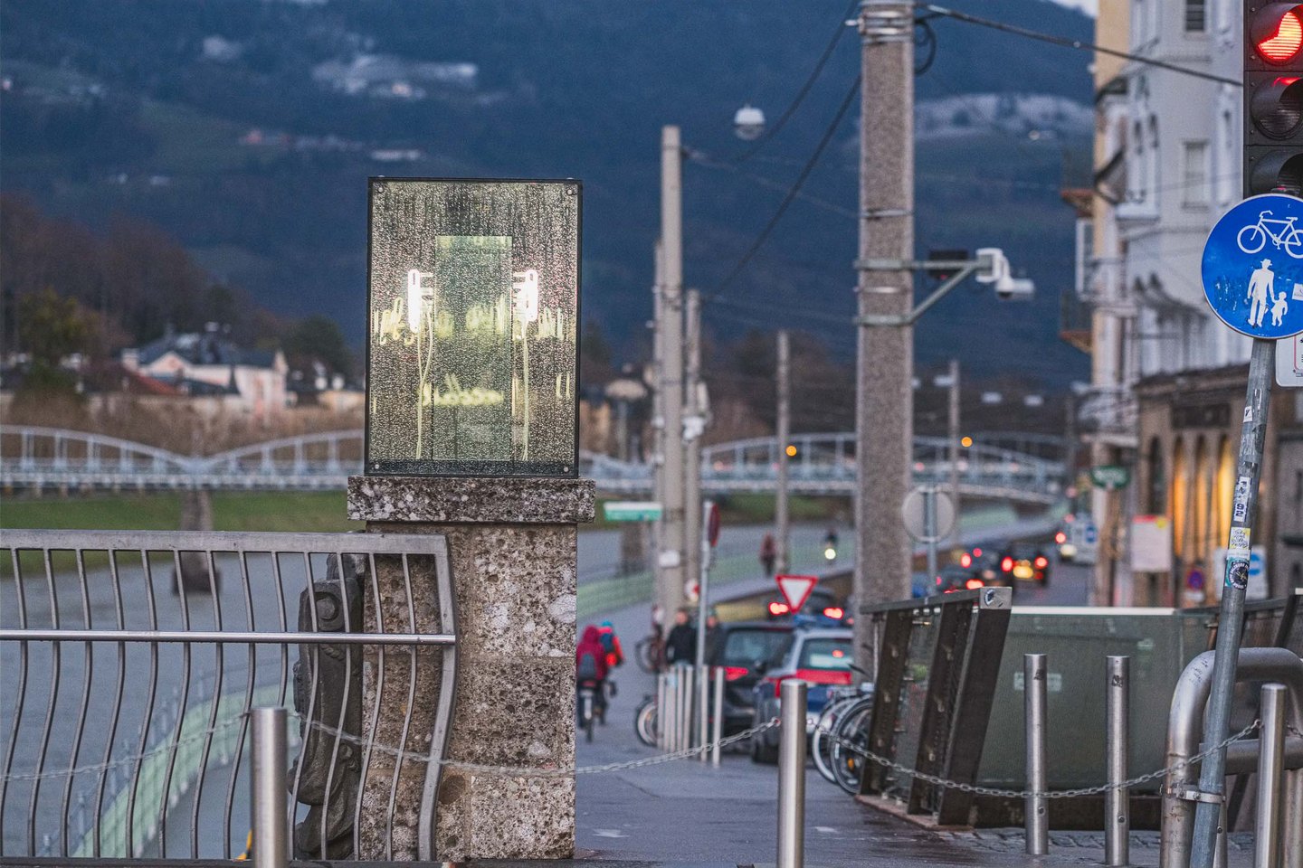 Neon script cube of the Beyond Recall memorial by Brigitte Kowanz on the Staatsbruecke in Salzburg at dusk