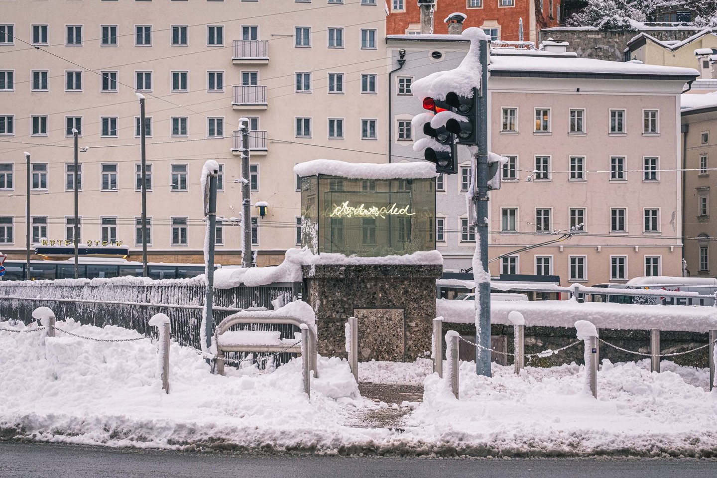 Beyond Recall illuminated artwork by Brigitte Kowanz on the Salzach embankment in winter snow in Salzburg