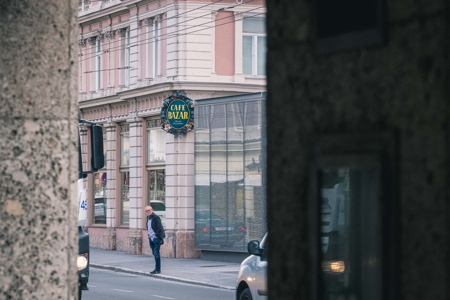 Cafe Bazar sign and facade glimpsed across Schwarzstrasse in Salzburg Neustadt.