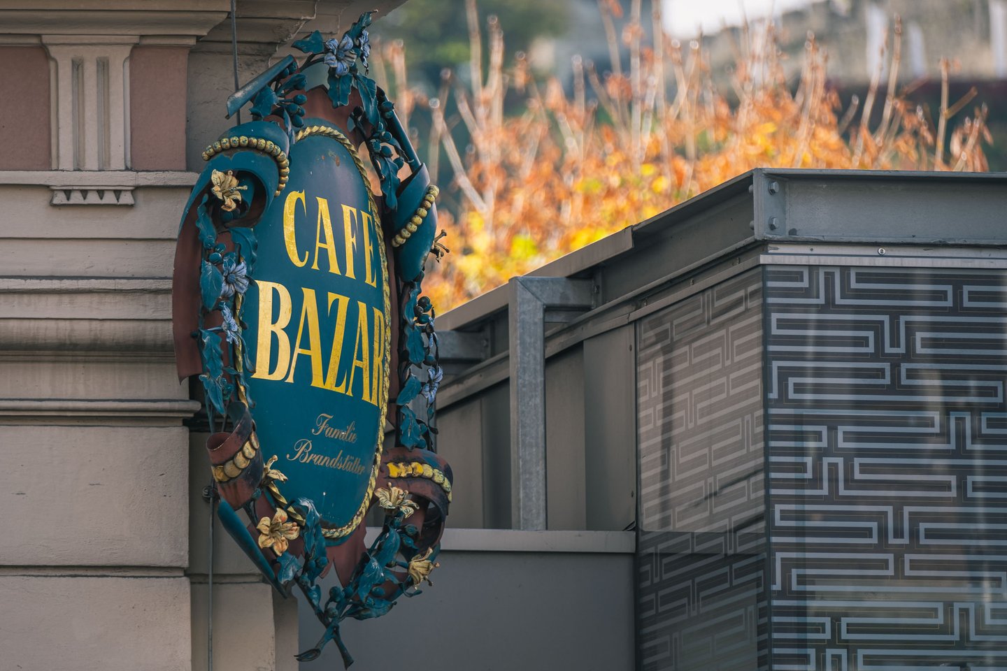 Ornate wrought iron Cafe Bazar sign mounted on the facade in Salzburg old town