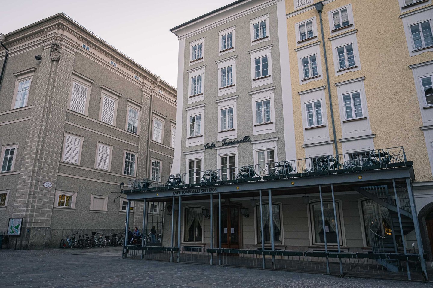 Cafe Tomaselli covered terrace on Alter Markt square in Salzburg old town.