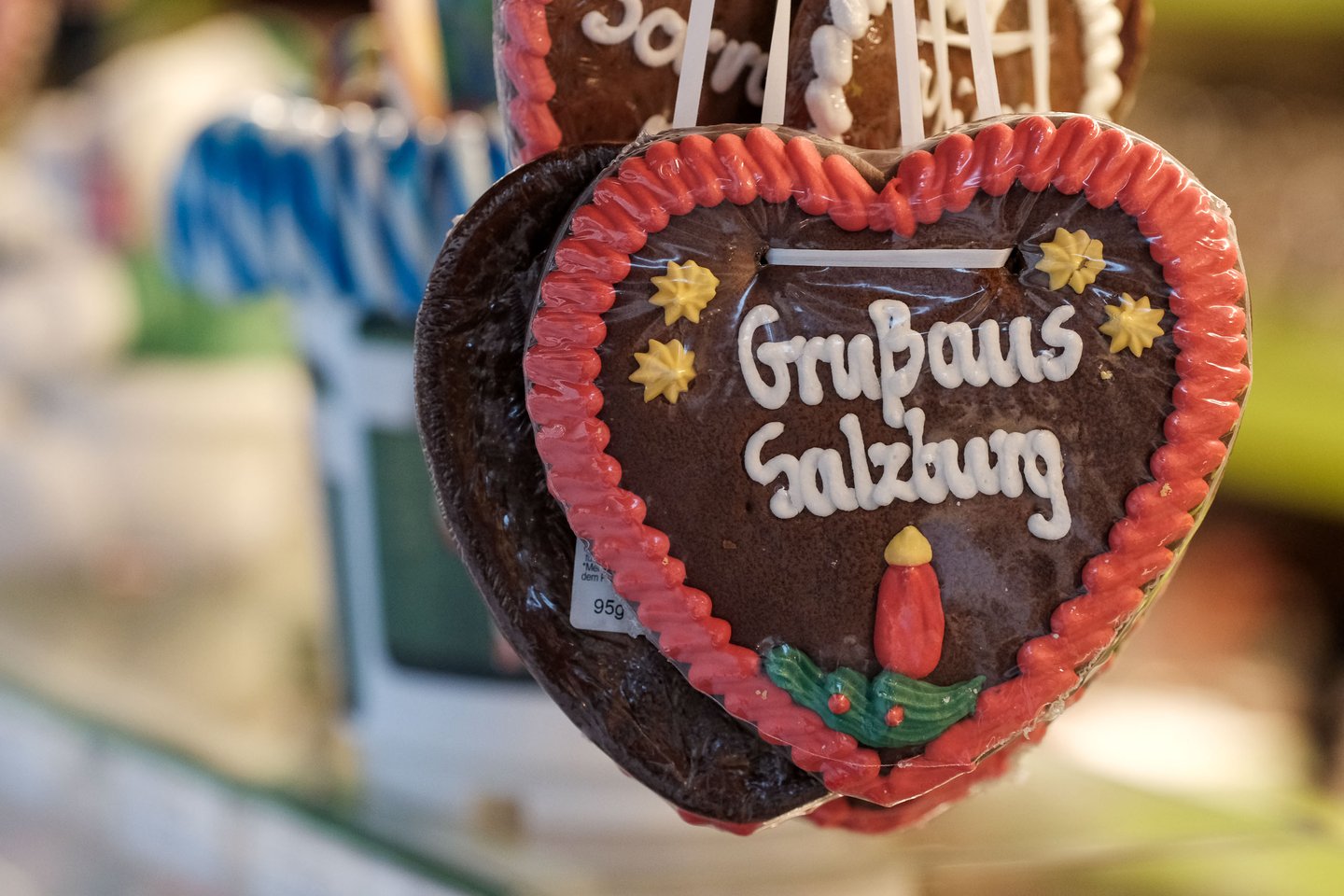 Gingerbread heart with Gruss aus Salzburg icing hangs at a Christmas market stall in Salzburg.