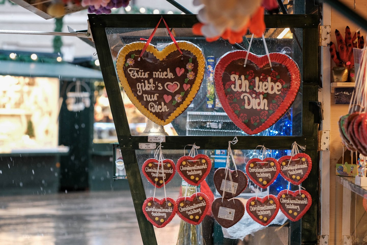 Gingerbread hearts labeled Christkindlmarkt Salzburg hang at a Christmas market stall in Salzburg.