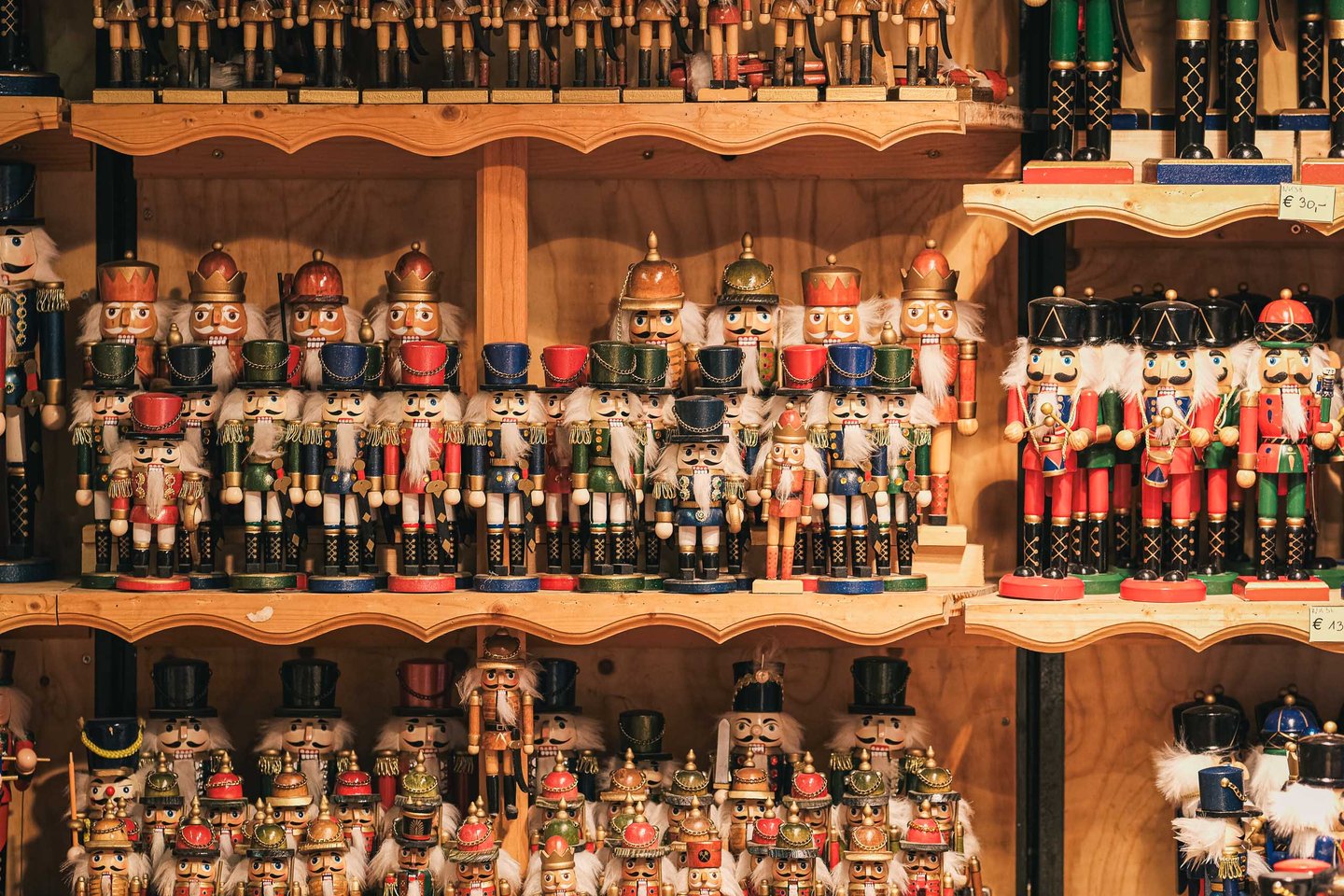 Rows of traditional wooden nutcrackers stacked on market stall shelves in Salzburg.