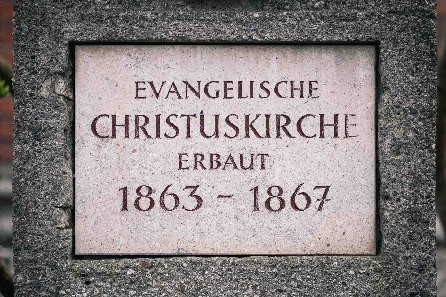 Stone plaque reading Evangelische Christuskirche erbaut 1863 to 1867 in Salzburg