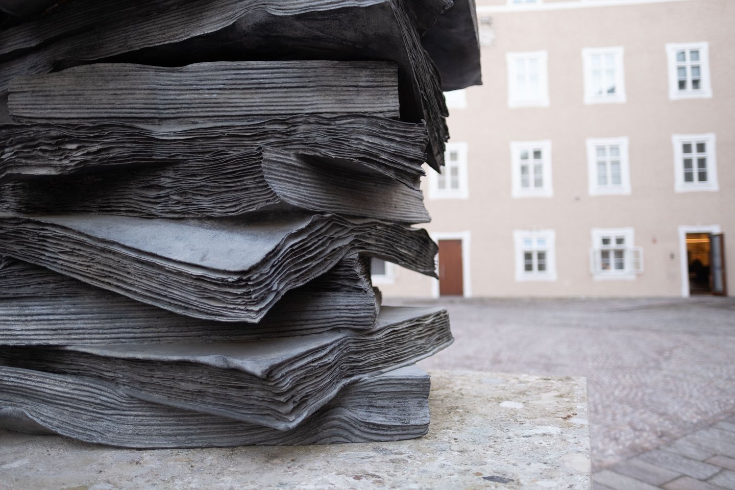Detail of the bronze book stack in Anselm Kiefer Die Sprache der Voegel sculpture at the university courtyard in Salzburg.