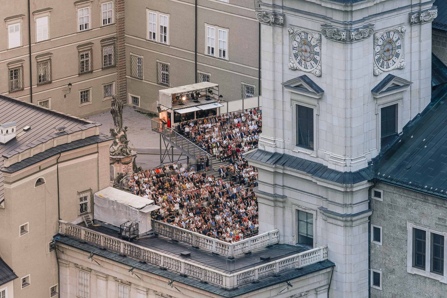 Audience seated before the Jedermann stage on Domplatz beside the cathedral in Salzburg.
