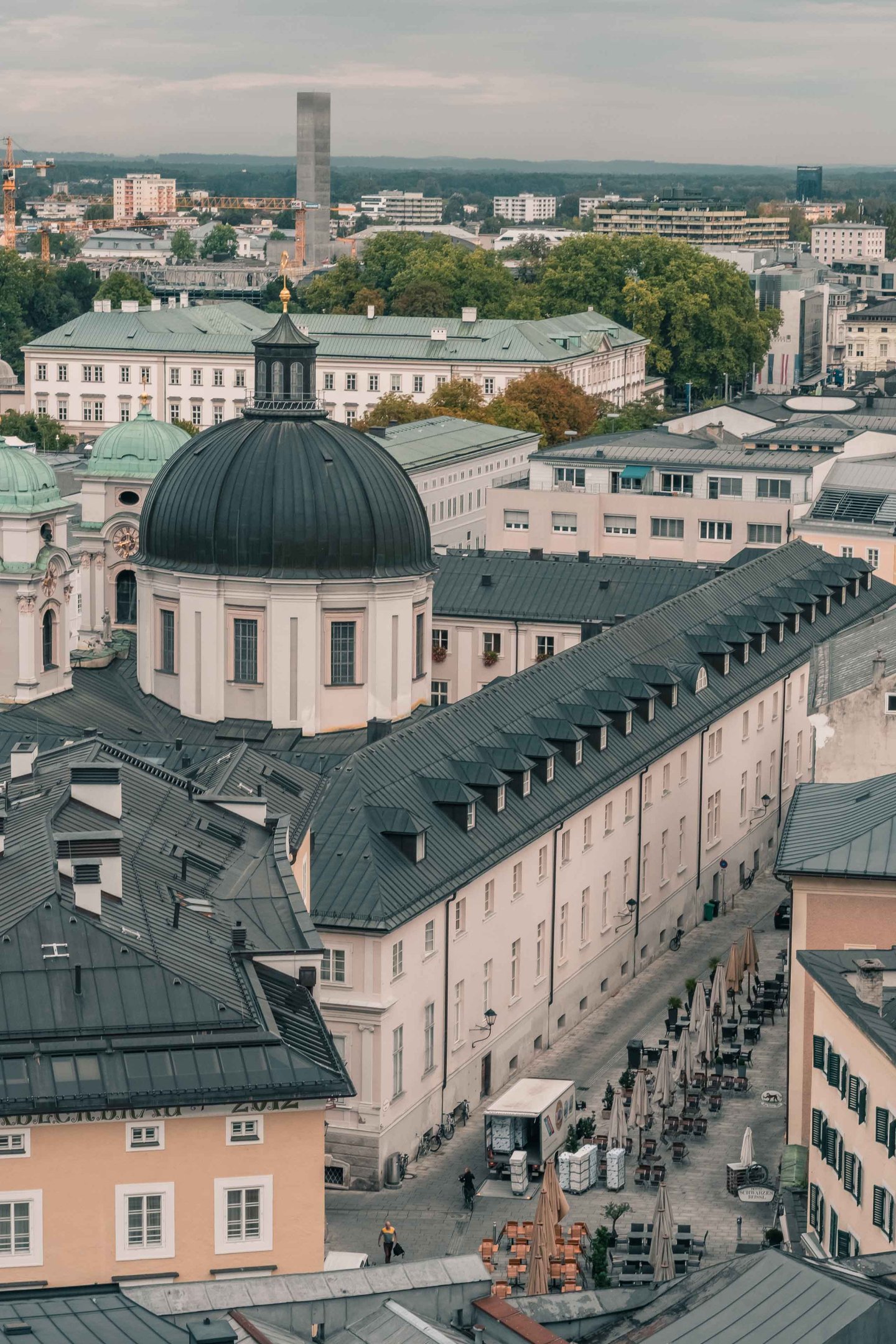 Dreifaltigkeitskirche green dome and long monastery roof in Salzburg Neustadt seen from above