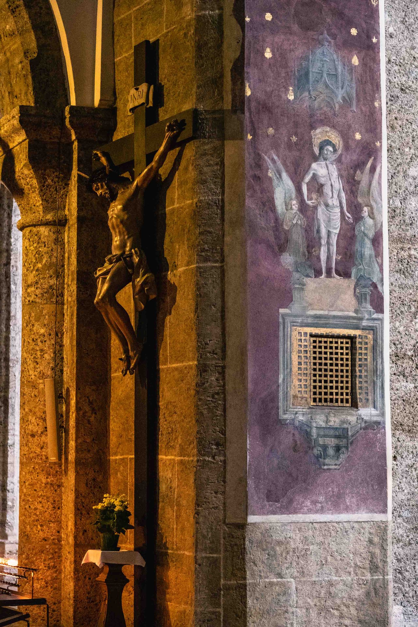 Crucifix and resurrection fresco on a pillar inside Franziskanerkirche in Salzburg.