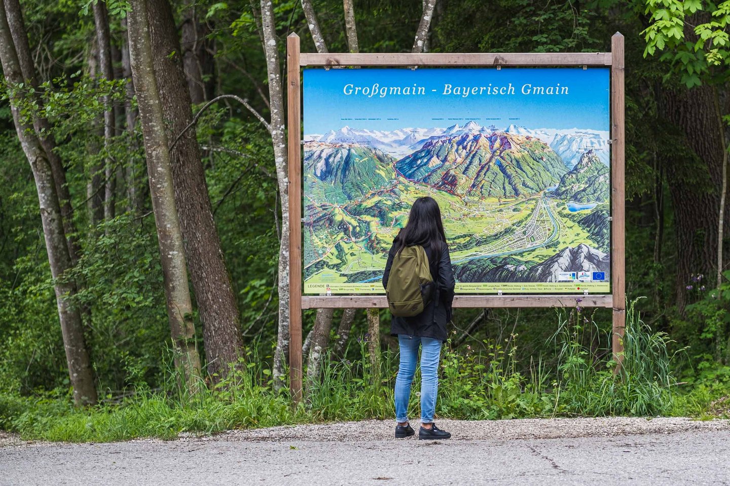 Visitor reads a Grossgmain and Bayerisch Gmain area map panel at the Salzburg Open Air Museum.
