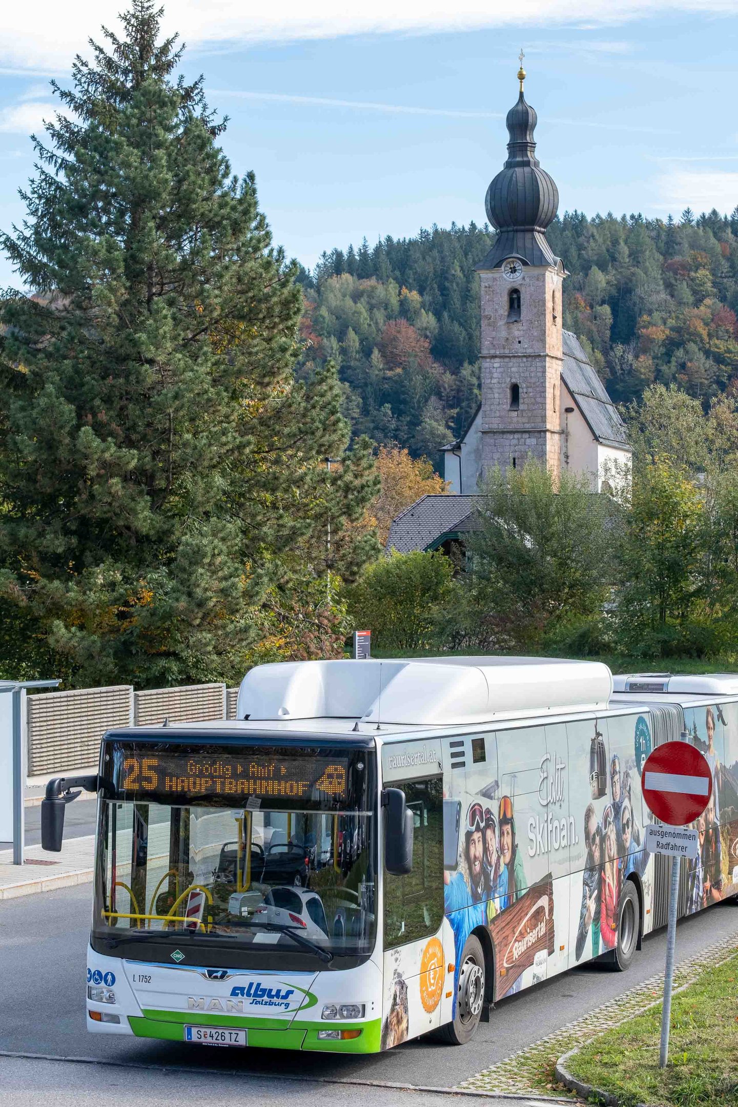Bus line 25 to Hauptbahnhof at Grodig Untersbergbahn stop with parish church tower behind