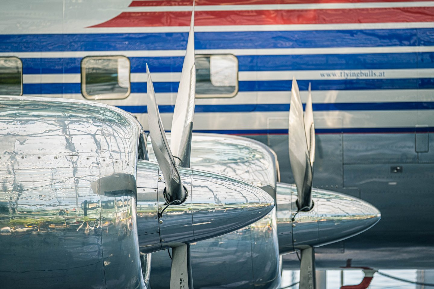 Polished propellers and a Flying Bulls fuselage with the flyingbulls.at logo on display at Hangar-7 in Salzburg.