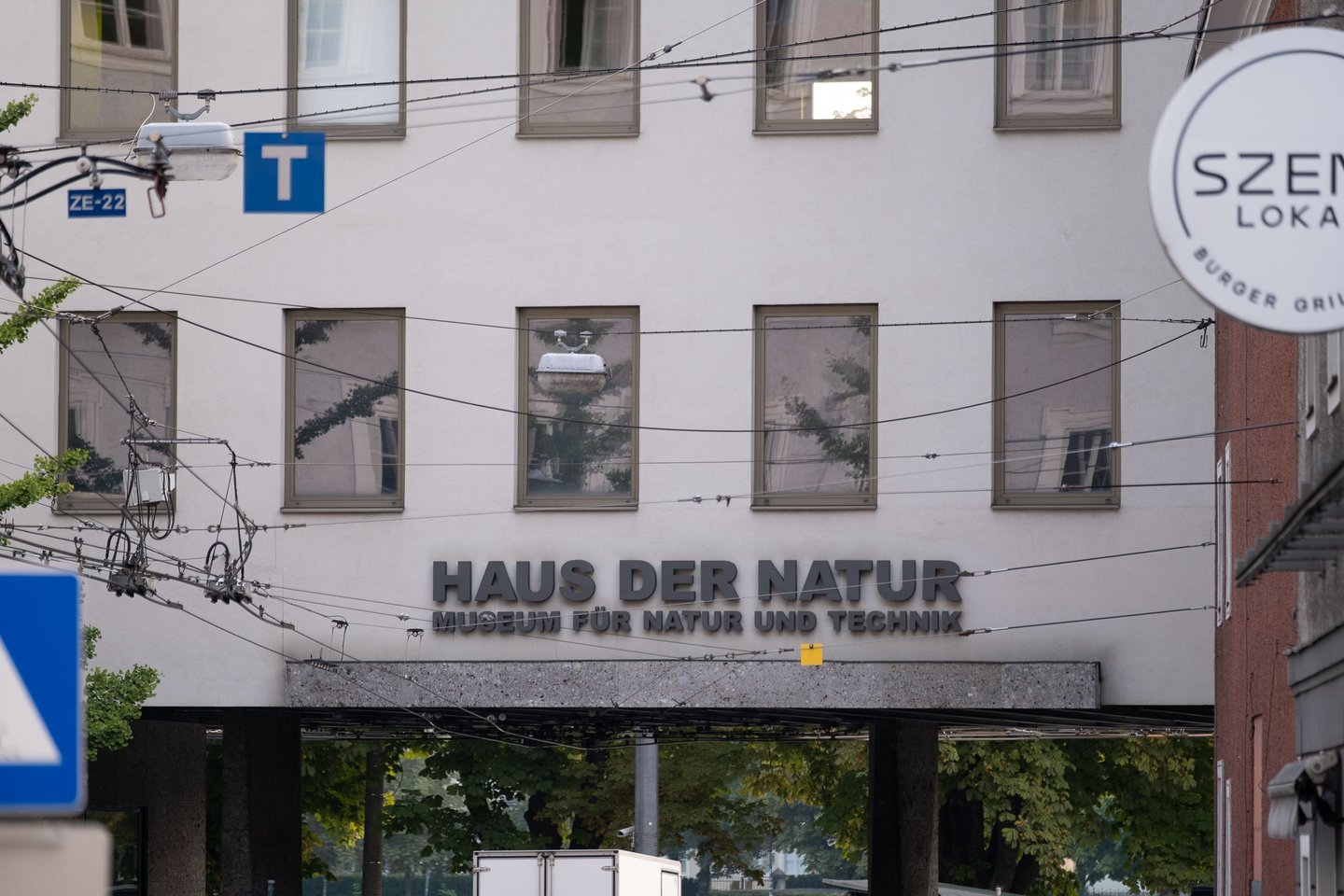 Haus der Natur museum signage above the main entrance with tram wires overhead in Salzburg