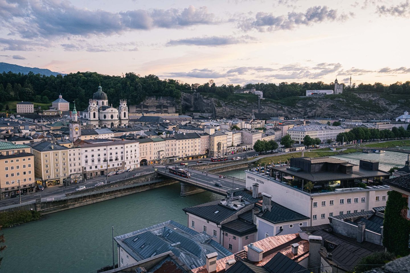 Altstadt rooftops and Kollegienkirche dome with Hotel Stein from Hettwer Bastei in Salzburg.