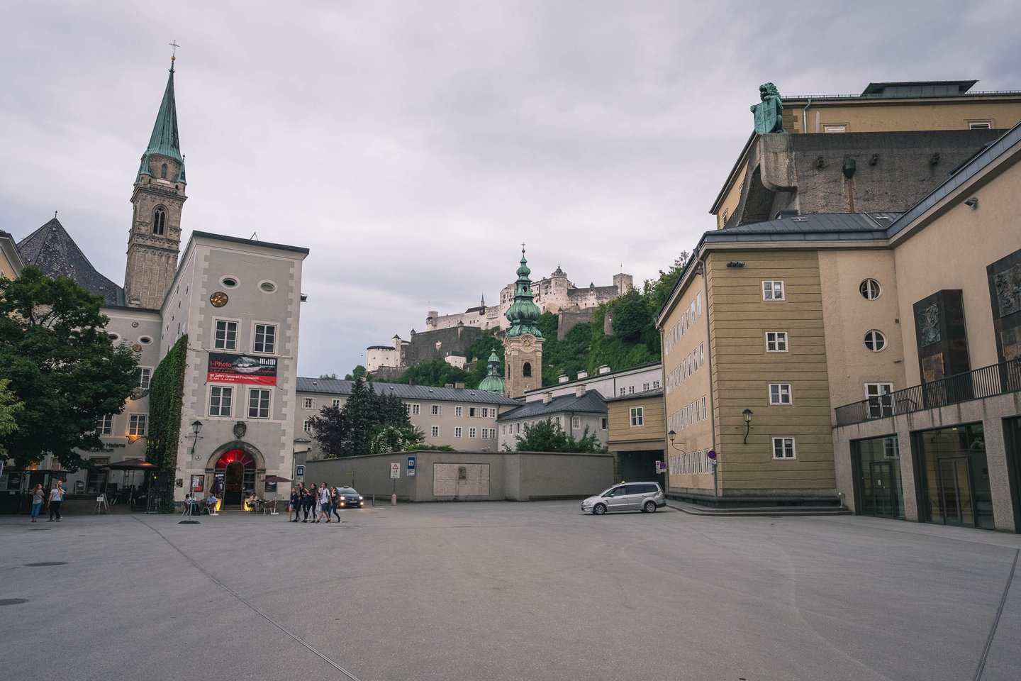 Open square in front of Festspielhaus with Michaelskirche spire and Hohensalzburg fortress behind