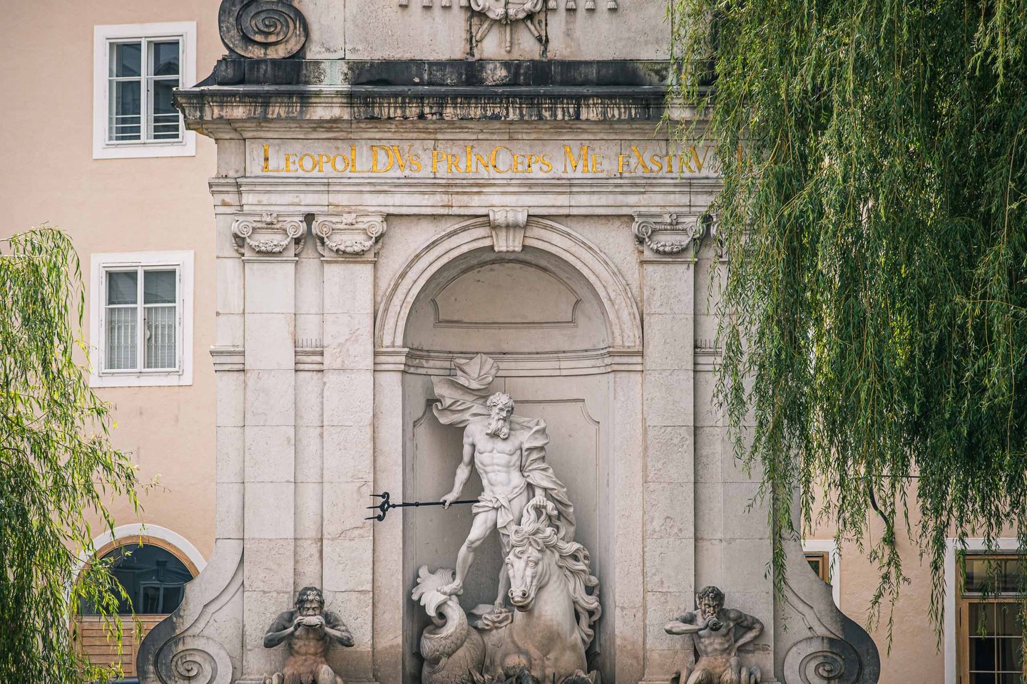 Neptune statue with trident and seahorses on the Kapitelschwemme horse pond at Kapitelplatz in Salzburg old town.