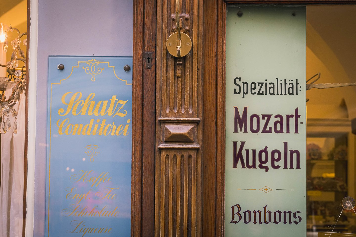 Schatz Konditorei storefront with Mozartkugeln advertisement in Salzburg old town