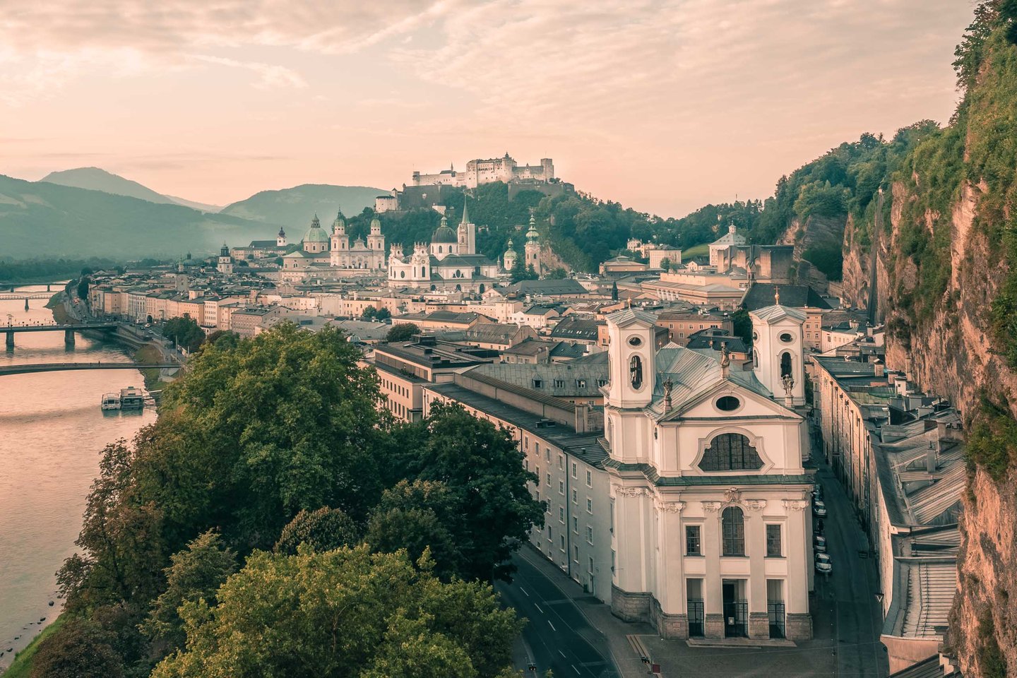 Markuskirche in the foreground with Hohensalzburg Fortress and the cathedral beyond in Salzburg old town.