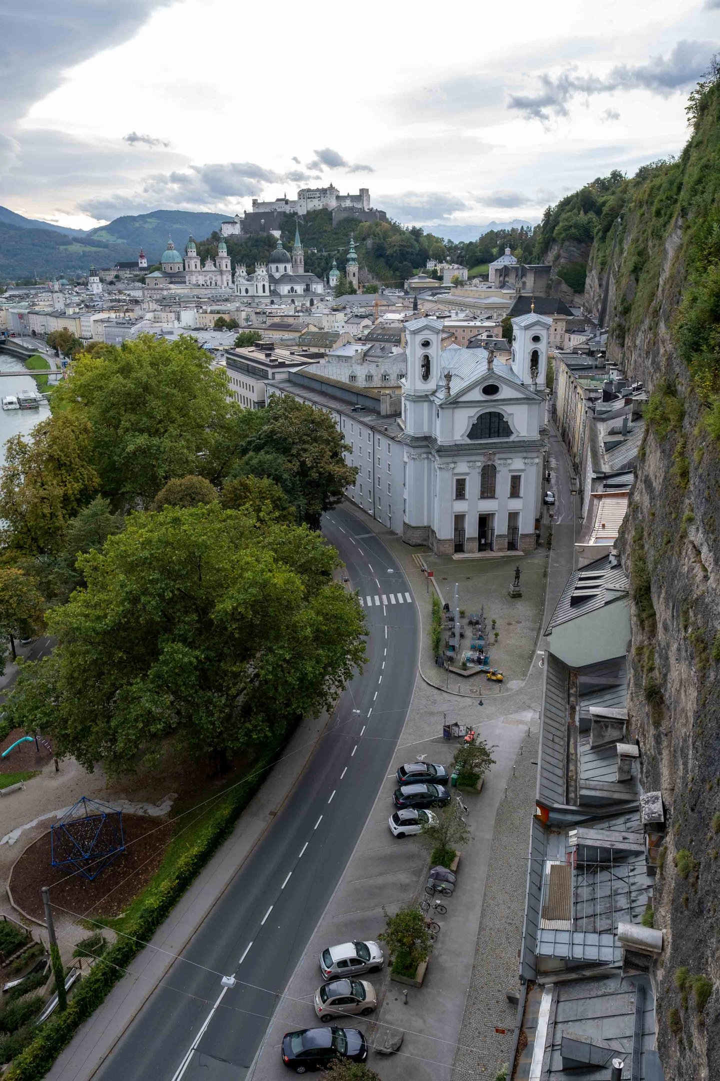 Baroque facade of the Markuskirche seen from Humboldtterrasse with Hohensalzburg Fortress in the distance