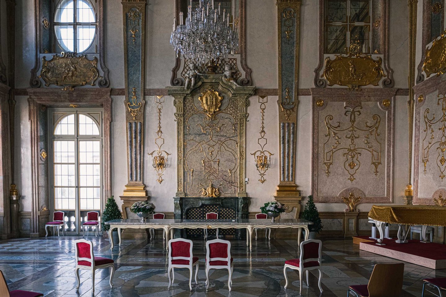 Baroque Marble Hall interior with chandelier and gilded stucco at Mirabell Palace in Salzburg