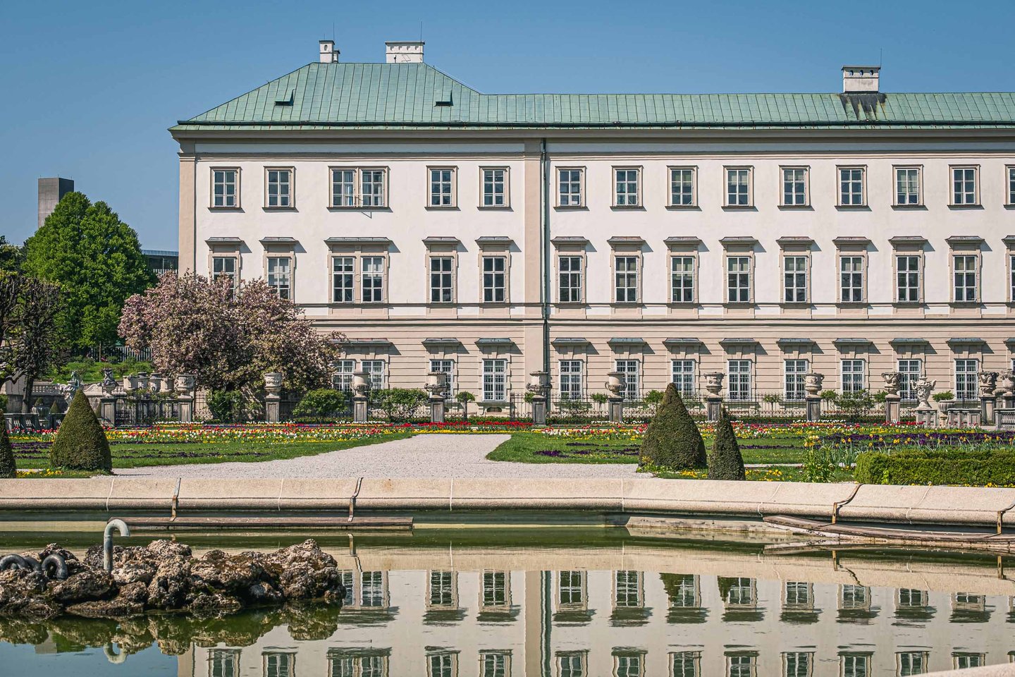 Mirabell Palace reflected in the Pegasus pond of Mirabell Gardens in Salzburg.