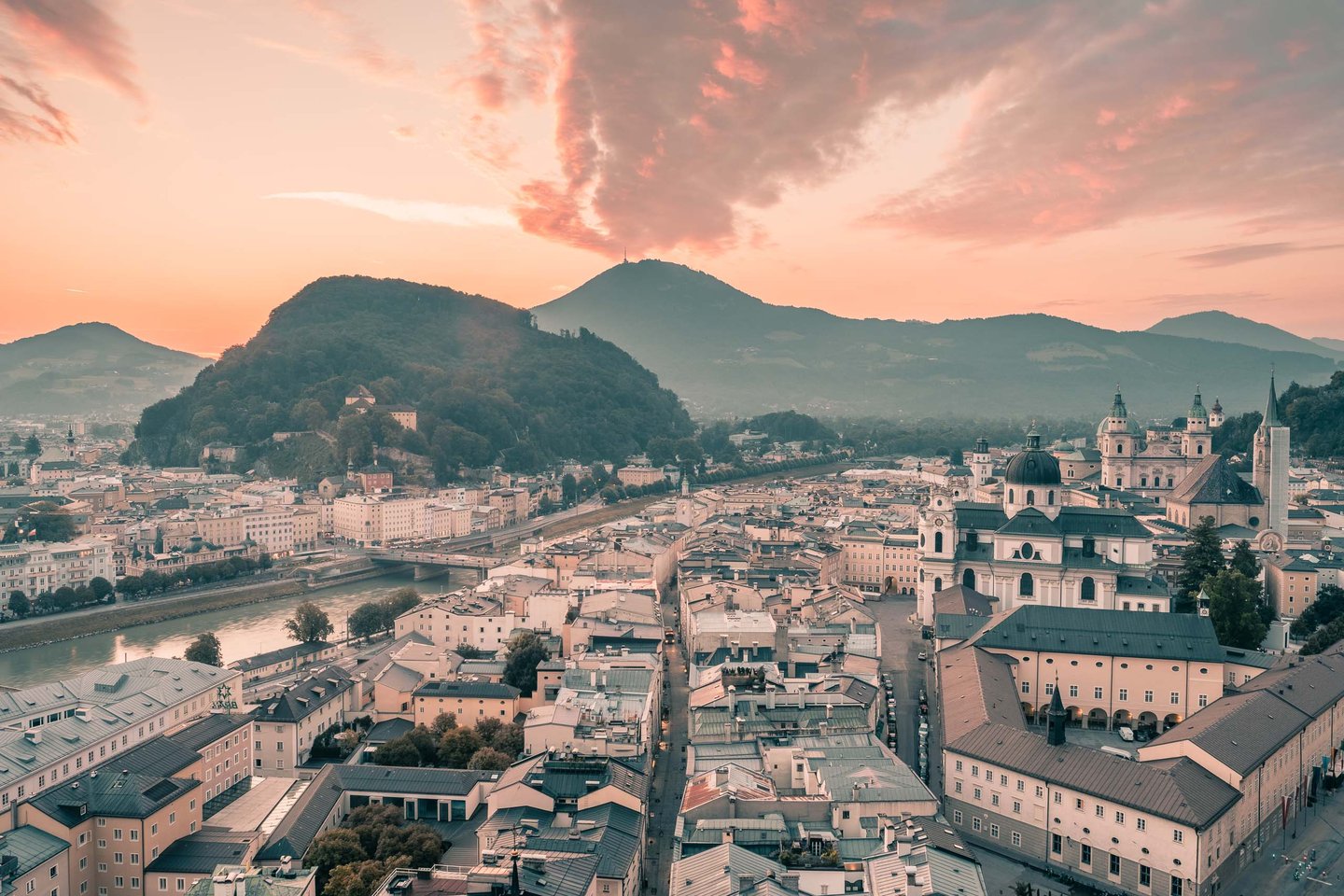 Sunset panorama over Salzburg rooftops with Kapuzinerberg and Gaisberg from Monchsberg in Salzburg