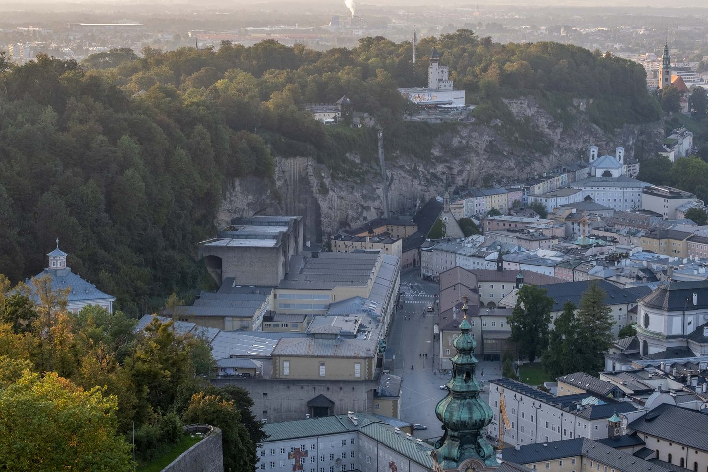Moenchsberg cliff with Museum der Moderne tower above the Felsenreitschule and Altstadt rooftops in Salzburg