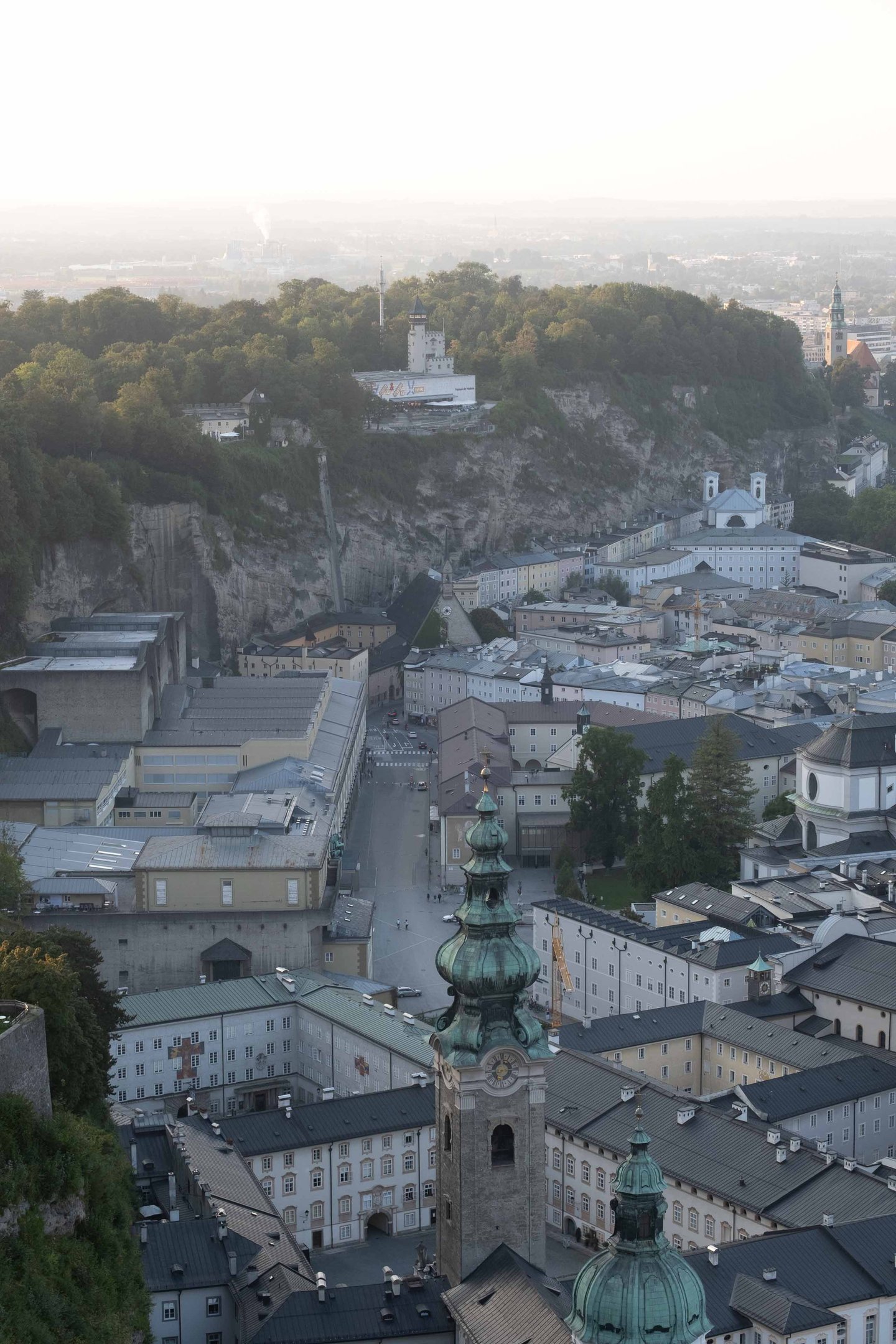 Moenchsberg cliff and Museum der Moderne tower rise above Altstadt rooftops seen from Hohensalzburg Fortress