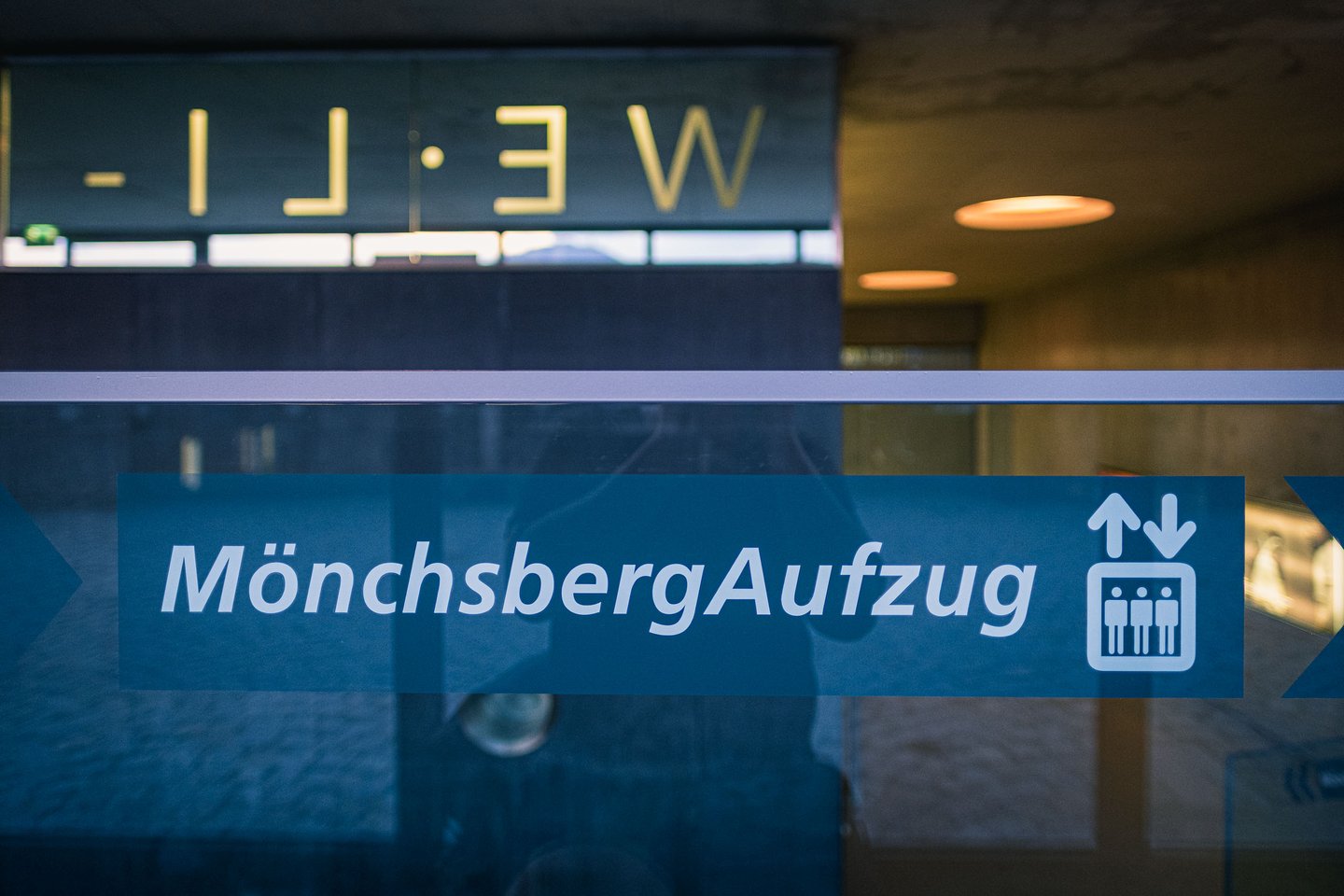 Moenchsberg Aufzug blue sign on glass entrance of the Moenchsberg elevator in Salzburg.