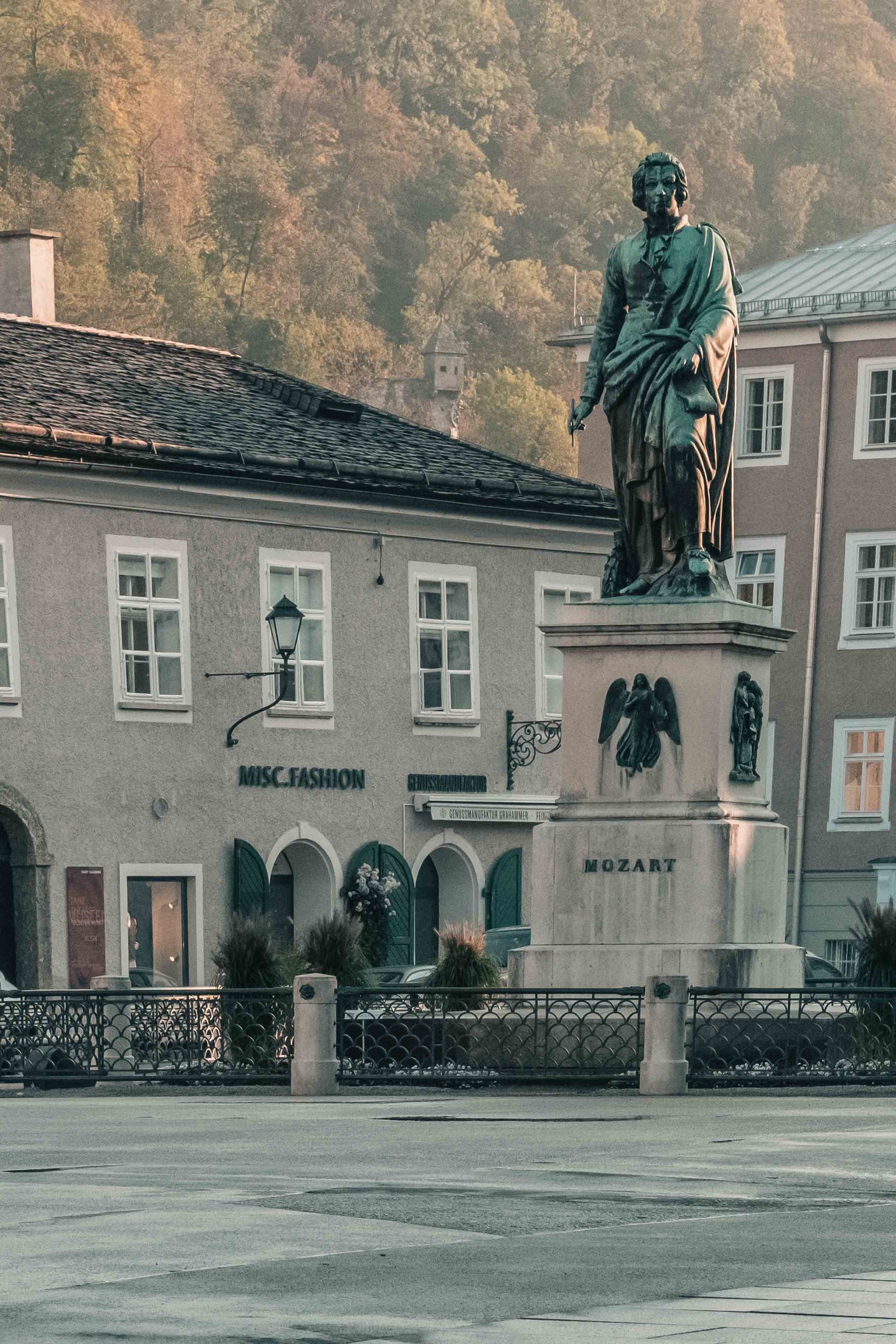 Bronze Mozart statue on its pedestal on Mozartplatz in Salzburg old town.