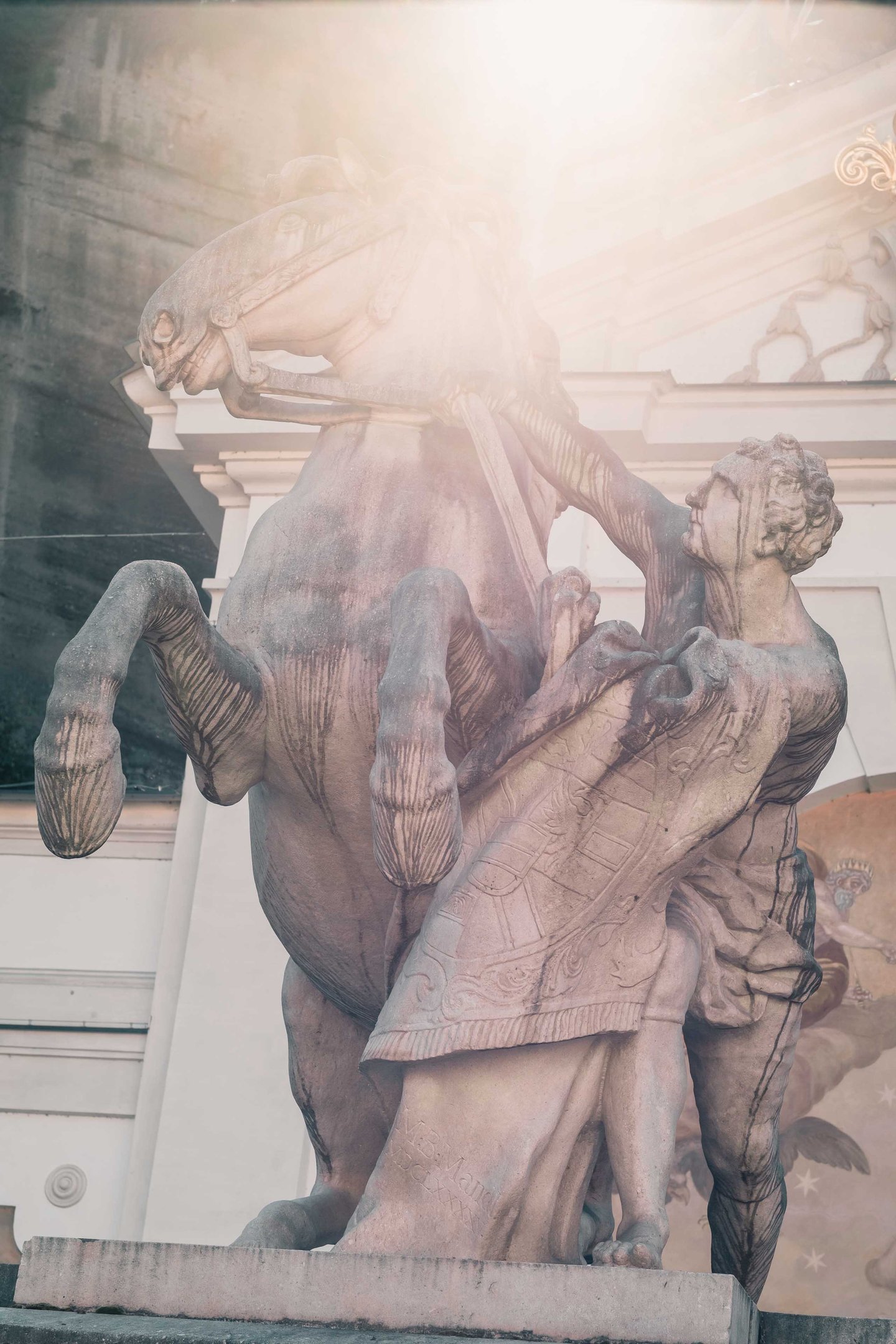 Pferdeschwemme horse and tamer sculpture backlit by sunlight in Salzburg old town