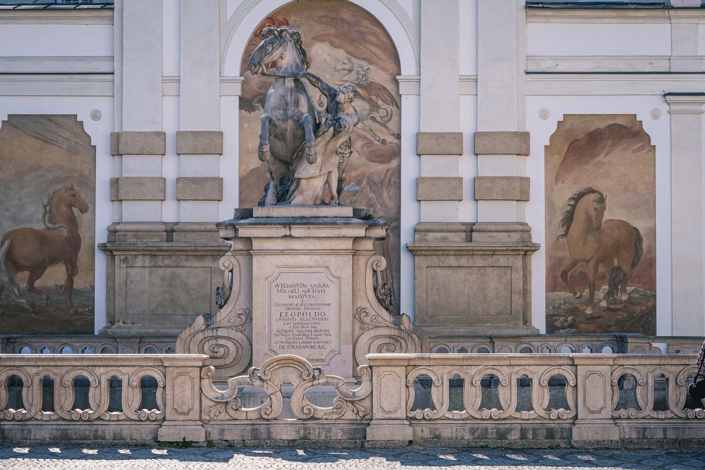 Pferdeschwemme horse trough monument with rearing horse statue and flanking frescoes in Salzburg