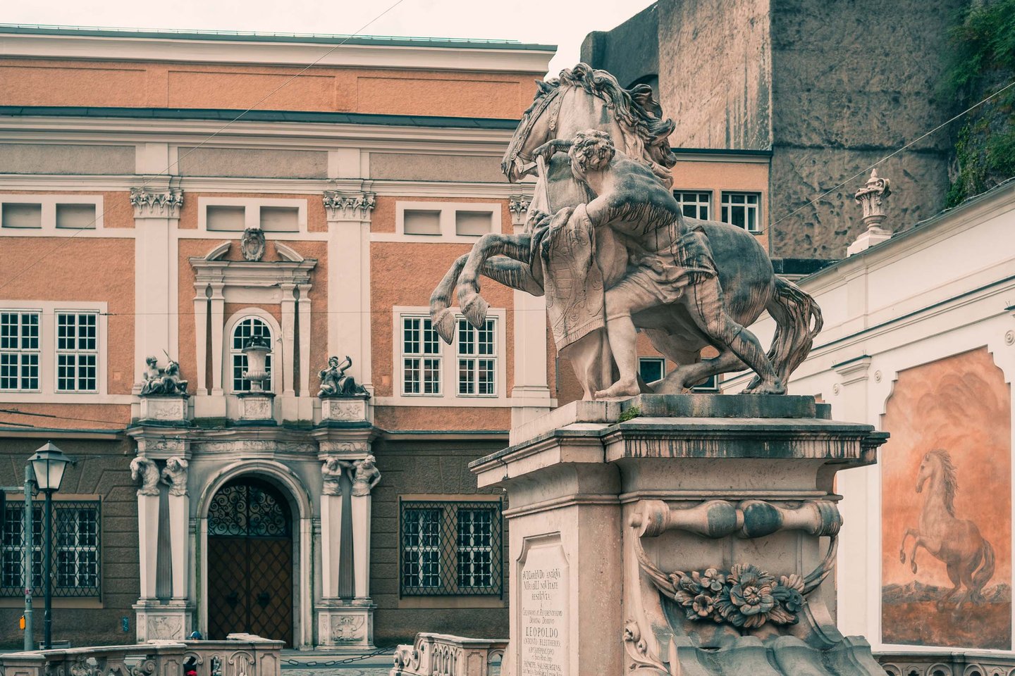 Pferdeschwemme horse sculpture with baroque Festspielhaus facade behind in Salzburg old town